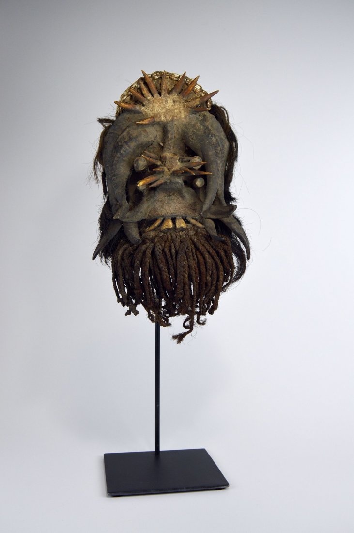 Amazing Gere Magic fetish African Mask w/ wild regalia: This is a wild and fantastic Gere Wobe peoples mask from the Ivory Coast, West Africa. Carved heavy dense wood with a heavy encrusted patina and adorned with goat horns and bone spikes and teeth, all 