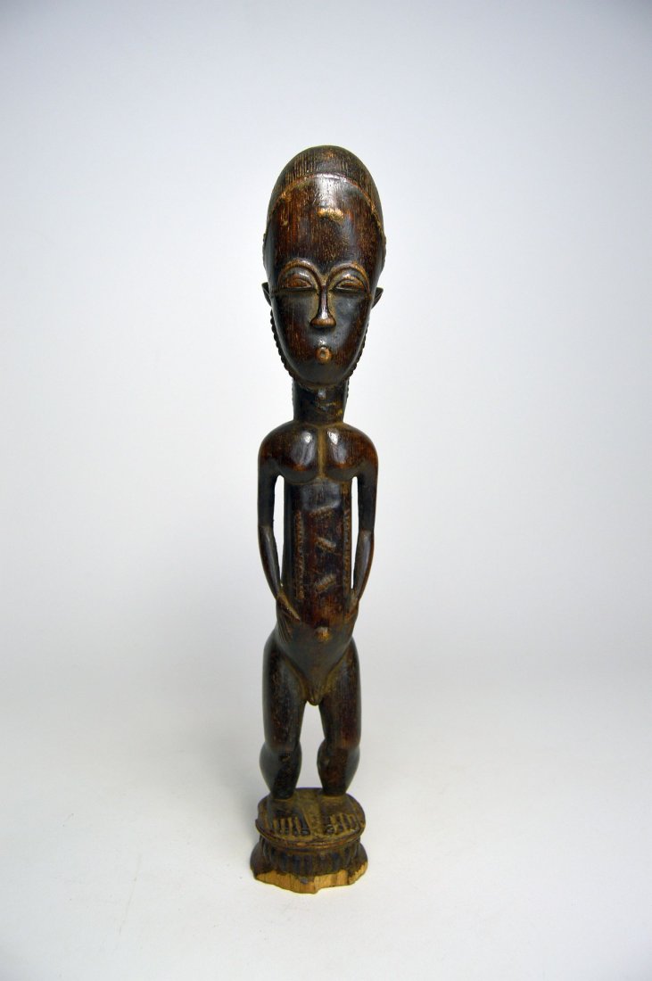 Handsome old Baule Male sculpture, African Art: Carved wooden male effigy with a very handsome face and form, raised tribal scarification as well as a beard a finely incised coiffure. The statue has some handling and wear, suggesting some age howev