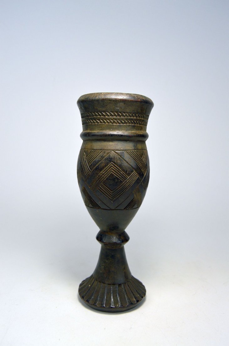 Elegant and refined Kuba Palm wine cup with designs: A very finely crafted wooden chalice or cup with flared rim, raised and incised linear deligns and scalloped base. Kuba peoples, Congo, Africa. Measures 7.75 inches tall.