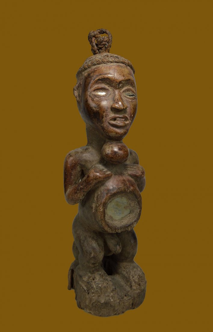 Old Yombe Magic fetish Ex Bonhams, African Art: A Old and interesting carved wooden magic fetish with woven rope cap, inset glass mirror eyes, a carved goiter, chest cavity sealed with mirror glass and a very well weathered surface, suggesting actu