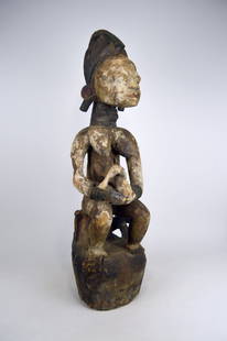 Eroded Yoruba Maternity Shrine Sculpture, African Art: A rare old female sculpture with child, all carved from a single piece of wood. This figure of a nursing mother was most likely part of a community shrine that honored the founding ancestors. Housed