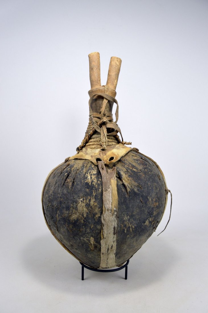 Large Old Turkana Camel Fat Vessel, African Art: This is a wonderful Vintage Old African Wood, Woven Twine and Leather Camel Skin Fat Jar from the Turkana People of Kenya. The camel skin fat jar is called an "akatom". This jug-shaped vessel is fashi