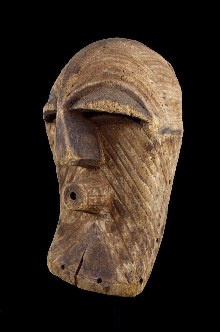 A FEMALE SONGYE KIFWEBE AFRICAN MASK: An old carved wooden mask in classic female form with incised linear designs and cubist like features. Songye peoples, DRC / Congo, Africa.Certain masking traditions of the Congo River basin personify
