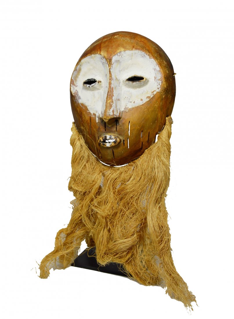 A Lega Bwami Society African Mask: A vintage to antique Wooden mask from the Lega peoples, DRC / Congo, central Africa. A very finely carved example of the Bwami Society masks in classic form, kaolin clay and mineral pigments accent ar