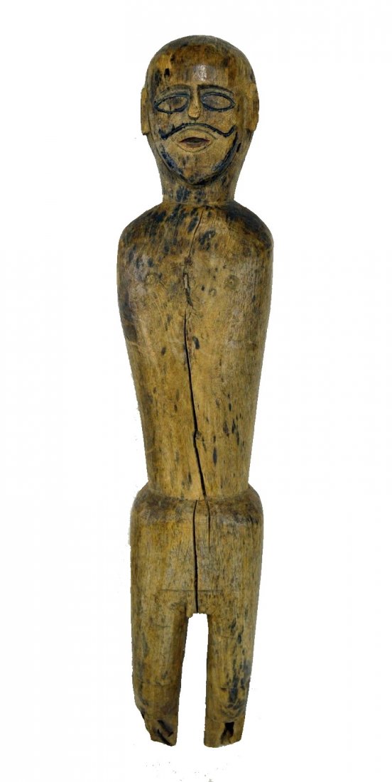 Old Guardian Sculpture from Nepal: A very old and fascinating wooden idol from Nepal. This is a genuine old example that was carved from a dense and heavy wood and features a finely carved face, more realistic than most, and even a nic
