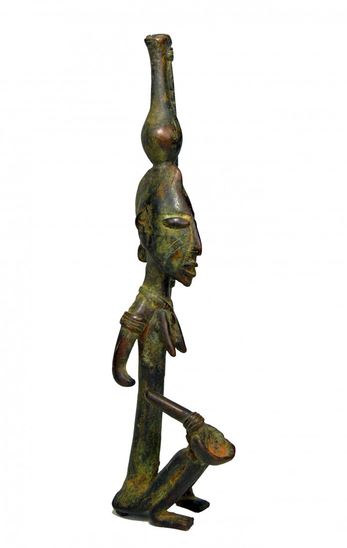 Dogon Bronze Female with Burden sculpture, African Art: Vintage to Antique cast bronze sculpture of a female carrying burden on her head and holding a small bowl on her knee. Note that the cast, done in the lost wax method was incomplete and the right arm 