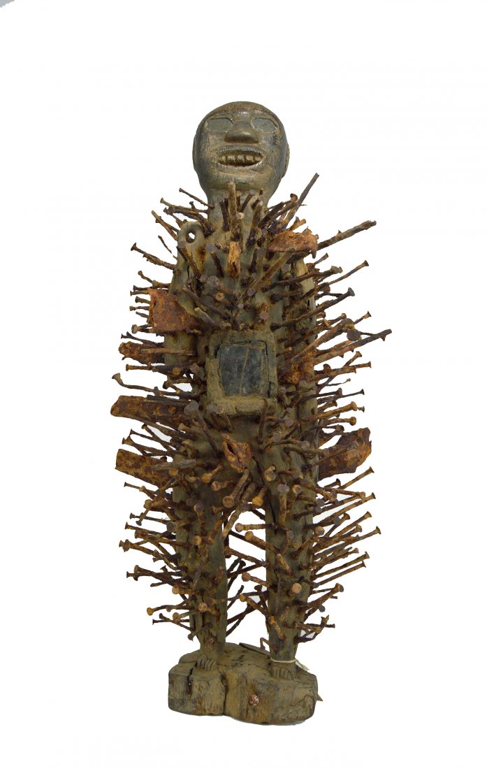 Striking Kongo Nkisi Nkondi Nail fetish, Art & Magic: A carved wooden male effigy with inset glass eyes, open mouth with carved teeth and numerous old iron nails and spikes driven into the figure. The wood is old and eroded on base. Kongo peoples, Congo,
