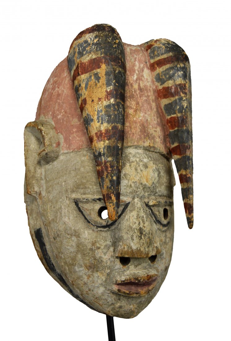 Old Yoruba Festival Mask, African Art: A carved wooden mask featuring traditional style face with long front locks, painted designs and obvious handling and wear. Old nails in the back suggest the mask was attached to a costume at some poi