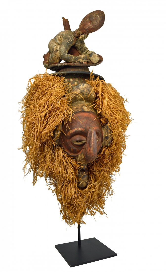 A Yaka Initiation Mask with Figure Performing Enema (1 of 9)