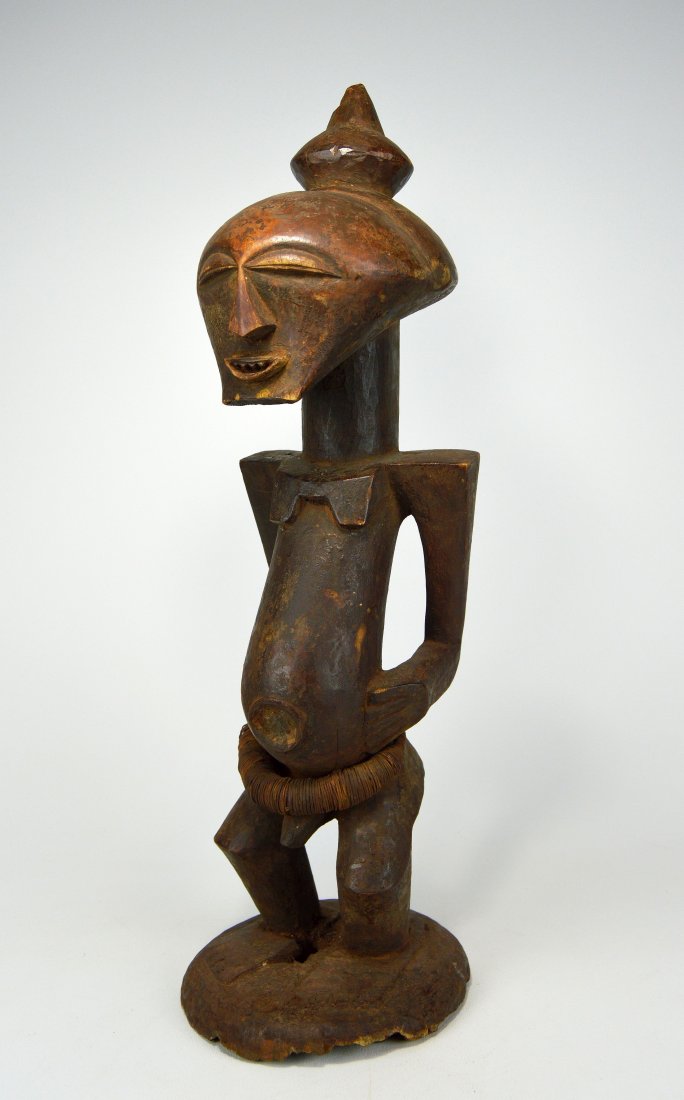 A Fine Luba Songye Male shrine sculpture, African Art: A very old and well handled example with highly stylized form and sharp features, including diamond shaped nose, carved wooden teeth stylized top knot and a wonderful well handled surface patina. The 