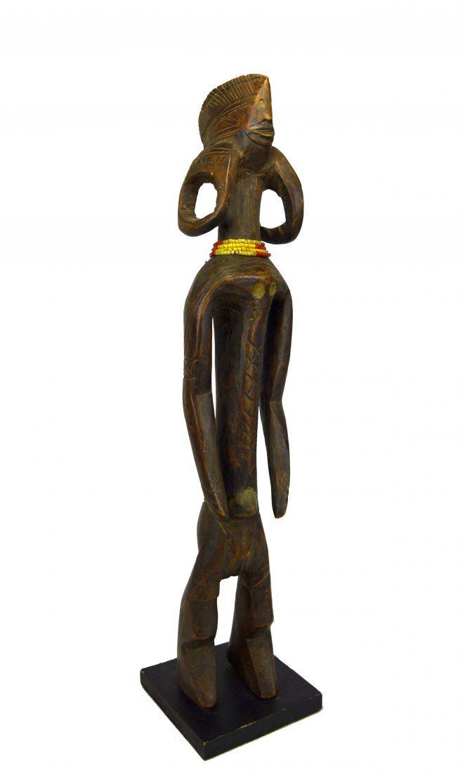 A Fine Mumuye iagalagana figure, African Art: Carved wooden female effigy with highly stylized ears, face, elongated arms and zig zag legs. Mumuye peoples, Nigeria, Africa. the figure has been mounted to a wooden base. The sculpture itself measur