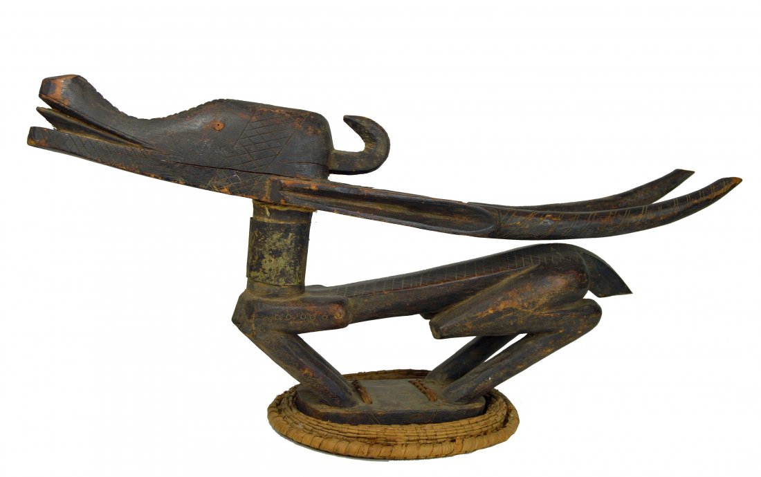 Old Bamana Chiwara Antelope Headdress: A Finely carved wooden headdress featuring the image of the mythical antelope Chiwara attached to basketry cap. The headdress shows plenty of handling and wear suggesting actual field use as a dance c
