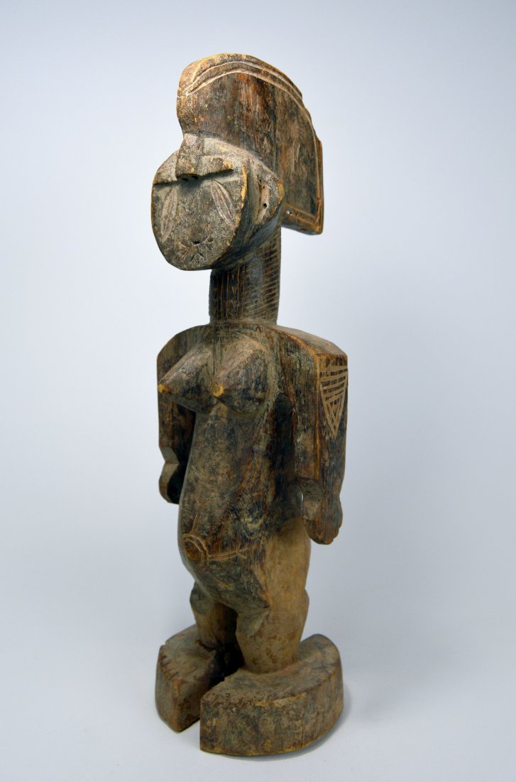 A Rare Idoma Female sculpture, African Art: A Highly stylized carved wooden female effigy with wonderfully abstract facial features and overall form. Idoma peoples, Nigeria, Africa. The sculpture measures 18.75 inches tall. Provenance: The Dr B