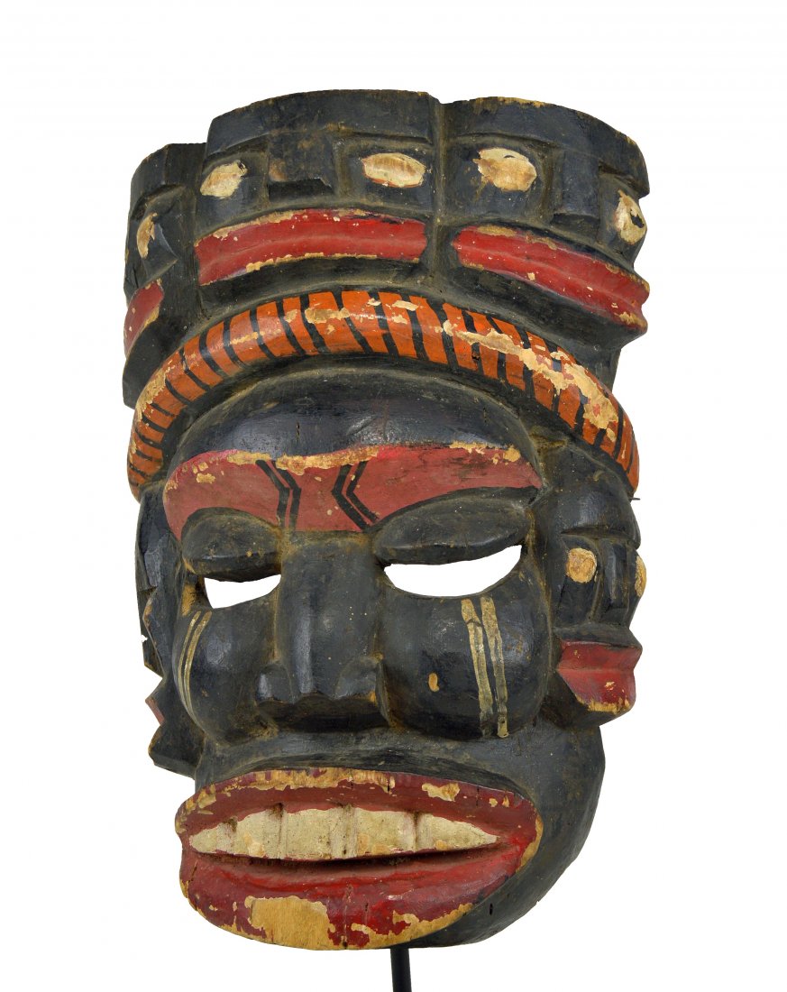 Vintage Ibibio Ekpo Society Mask, African Art: A Bold and powerful vintage to antique carved wooden mask with various faces, an exaggerated form and various painted designs. Ibibio peoples, Ekpo cult , Nigeria, Africa. The mask measures 18 inches.