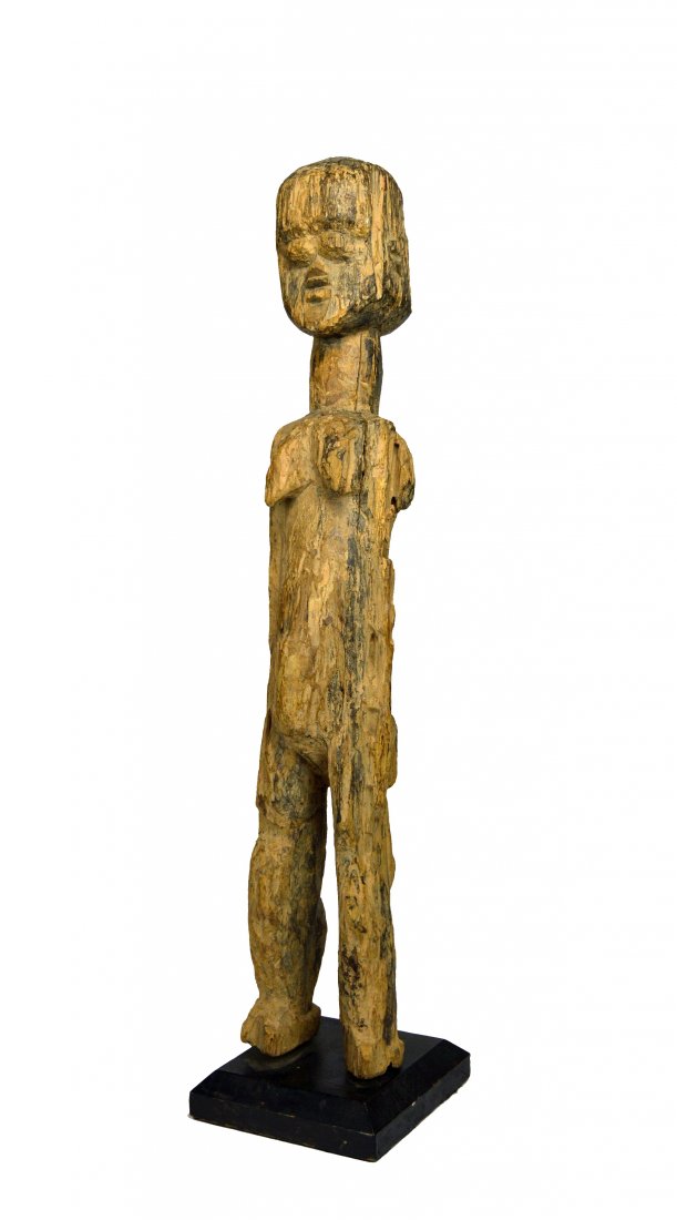 A Lobi Bateba Shrine Idol, African Art: A very old and weathered shrine idol with highly stylized facial features and a undeniable weathered surface. Lobi peoples, Burkina Faso, West Africa. The sculpture measures 22.25 inches tall on its c