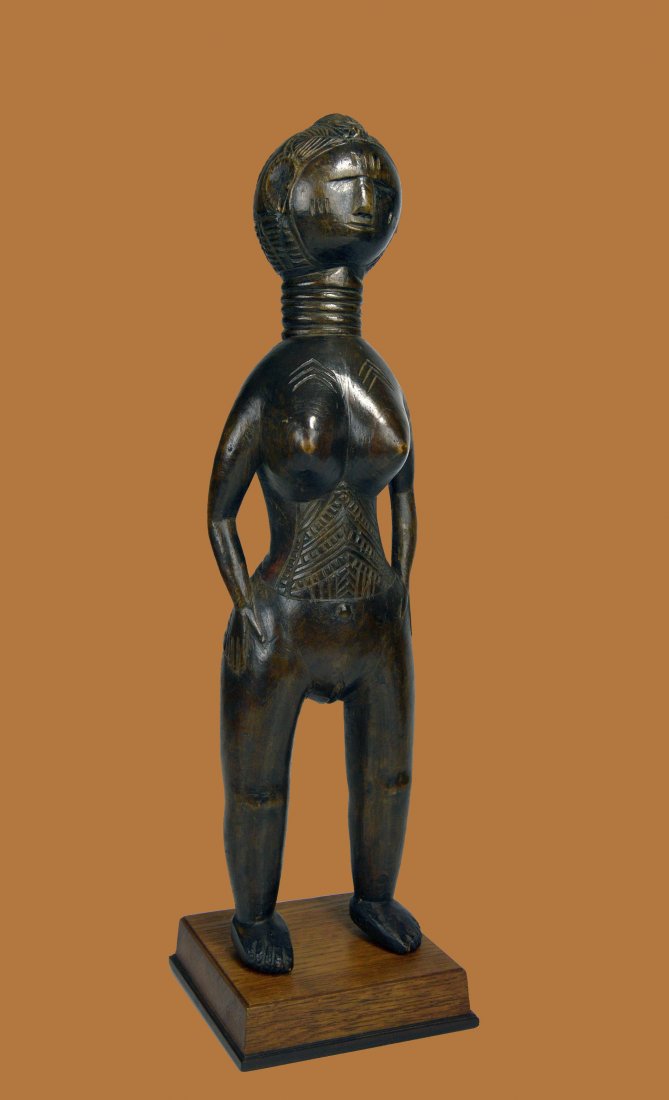 A Fine Mende Female Effigy , African Tribal Art: A finely carved wooden female effigy with a stylized face and form, incised tribal scar designs and a wonderful well handled glossy surface patina. Mende peoples, Sierra Leone, West Africa. The figure