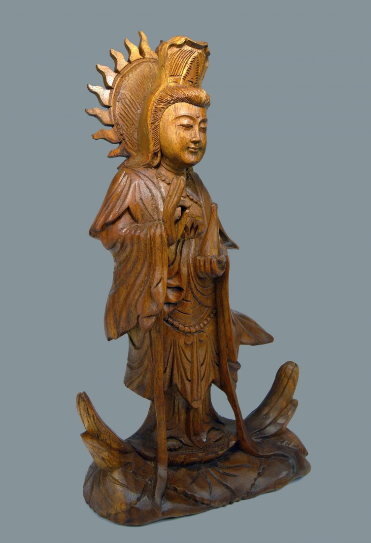 Serene Carved Wooden Kwan Yin Goddess Of Compassion: A finely carved wooden image of Kwan Yin, The Goddess of compassion and sometimes referred to as "The Mother of Buddhas". This finely crafted Kwan Yin was carved from Suar wood by an artisan in Tegall