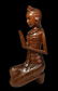 A Serene Carved Wooden Praying Balinese Woman