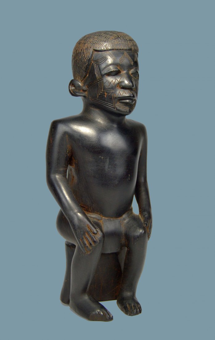 Antique Ironwood Sculpture of a Makonde Chieftan: A carved male effigy with classic facial scars and fine craftsmanship. The wood is incredibly heavy and dense ironwood. Makonde peoples, Tanzania, Africa. The sculpture measures 10.75 inches tall and 