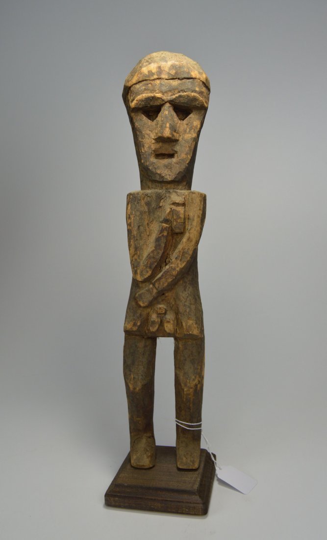 A Fine Old Guardian Sculpture from Nepal: A traditional carved wooden idol that would traditionally guard Village, shrines and crossroads. Nepal. Measures 17.5 inches tall on wooden base.Provenance: Ex Prof. Charles Bordogna, Past curator of 