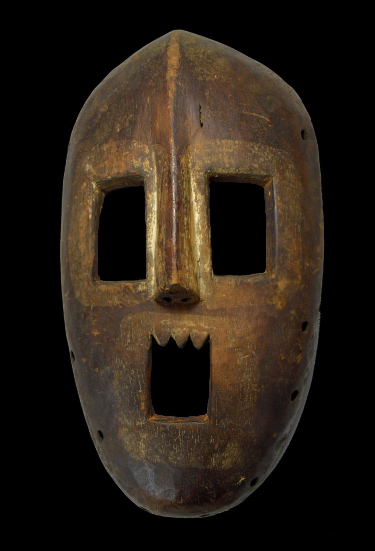 Rare Kumu African mask Ex Jean Pierre Hallet Collection: This is a fine and rare Kumu Nsembu mask from the Congo, central Africa. carved wood with remnants of white kaolin clay pigment around the open eyes and jagged cut teeth. The mask has a well handled s