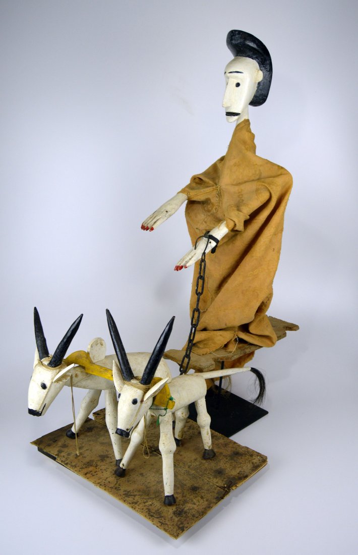 Published Farmer and his Oxen Sogo Bo Marionette: A carved wooden Farmer and his Oxen marionette from the Bamana peoples. This Sogo bo puppet has movable arms and would have at one time has a make shift plow being pulled by his two hump back oxen. Th