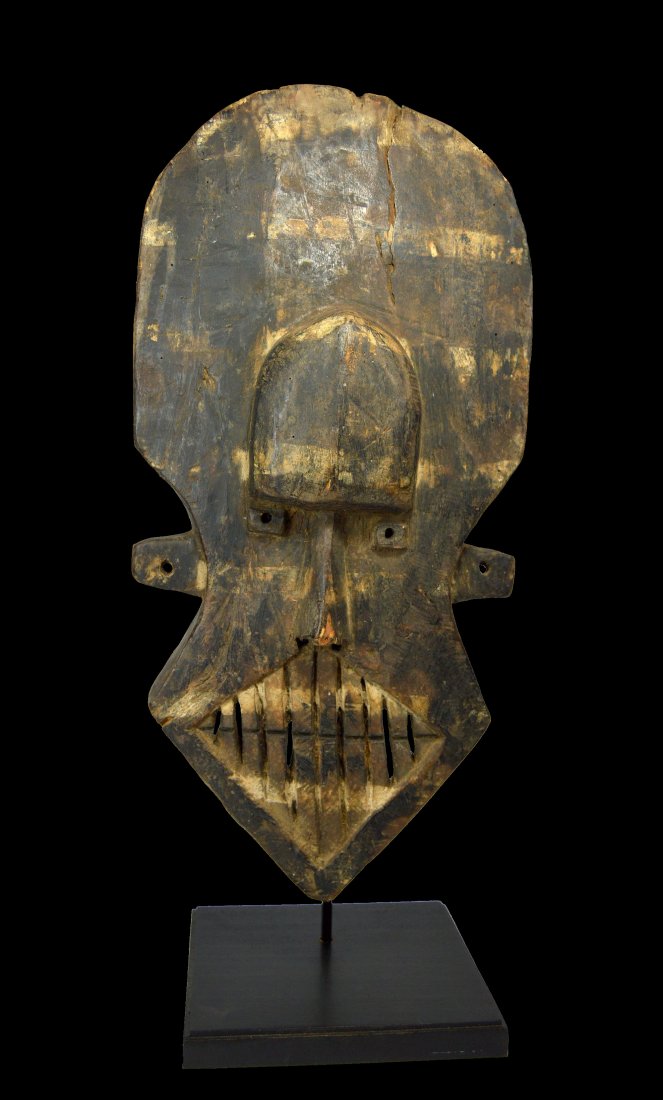 Dramatic Old Kuba Kete Mask collected prior to 1975: A rare aggressive Kuba Kete mask with stylized form and wide aggressive teeth. Kete peoples, Kuba sub group, DRC / Congo, central Africa. The mask measures 18 x 9.25 inches ( 22 inches on custom displ