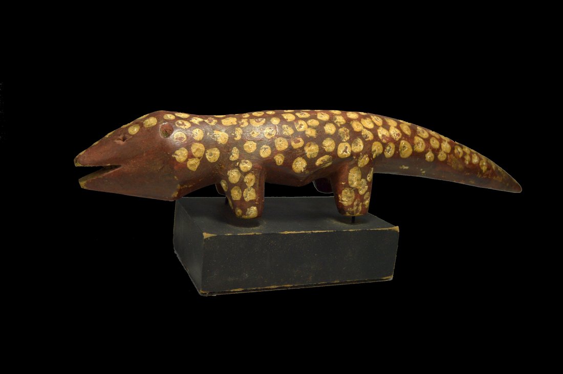 A Rare Lega Animal Totem Ex Leonard Kahan Gallery: A carved wooden zoomorphic sculpture with painted spots and well handled surface. The figure measures 12 inches long and has been mounted to a wooden display stand. Among the Lega, figurines depicting