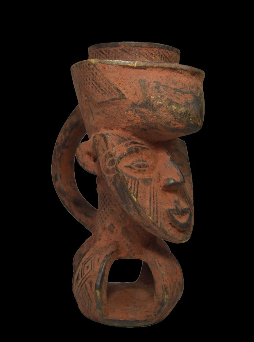 Kuba Palm Wine Cup Ex Mooney Field Collected before: A carved wooden palm wine cup with heavy reddish mineral pigment and classic form with incised designs. Kuba peoples, Congo, Africa. The cup measures 9 inches tall x 6 inches deep. Provenance: Field c