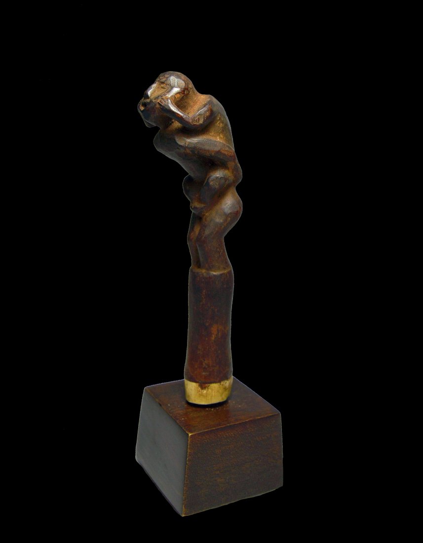 A Fine Old Lombok Island Chopper Handle: A carved wooden handle with unusual form of intertwined ancestor figures and with a small bone inlay. The handle was likely part of a betel nut preparatory kit. Lombok Island, Indonesia. The handle me
