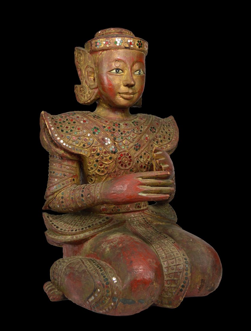 19th Century Mandalay Burmese Buddhist Monk sculpture: A finely carved wooden effigy of a devotional Monk with elaborate royal costume embellished with many small pieces of glass and mirror set into designs. The Monk sculpture is gold gilt with red lacque