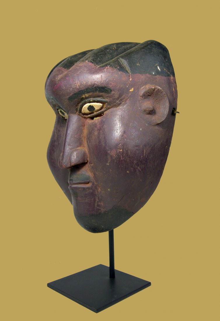 A Purple TIV African Mask: A carved wooden ceremonial dance mask with a highly exaggerated form and purple paint. Tiv peoples, Nigeria , most likely part of the Kwagh-Hir festival. A metal display stand can be included for an a