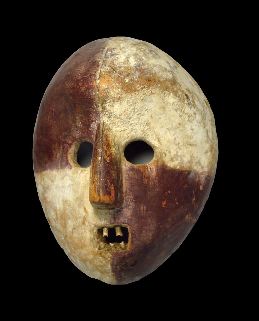A Rare Kumu African Mask Ex Gerena New York 1988: A carved wooden mask with natural mineral pigments of white and red as well as inset teeth. Kumu peoples, DRC / Congo, central Africa. Provenance: Ex. Joseph Gerena Fine arts, NY, 1988