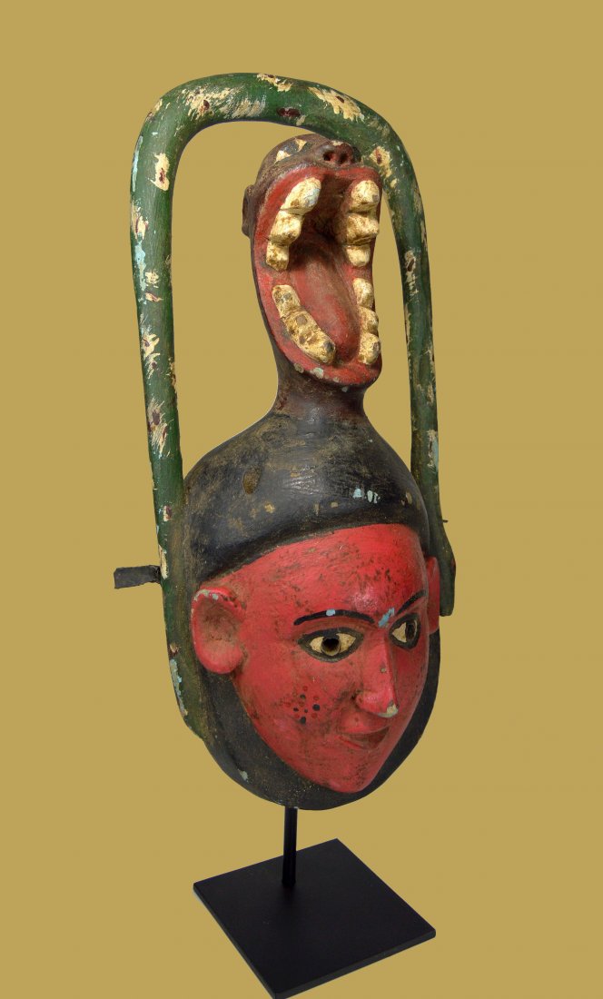 Ibibio Dance mask with Screaming Spirit & Serpent: A fantastic carved wooden mask with a highly exaggerated effigy of a screaming spirit above a serene face and surrounded by a snake. Ibibio peoples, Nigeria, Africa. The mask measures 18 x 8 inches. A