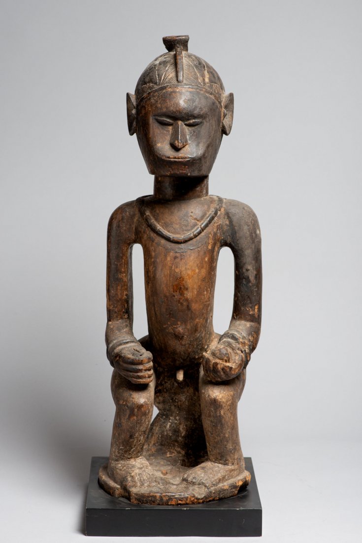 A Dramatic Idoma Shrine Figure, African Art: Wood statue. H: 29”. Early 20th century. Idoma. Nigeria. With base. Provenance: Donated by a member of The Ethnic Arts council of Los Angeles.All lots must be paid for after the auction, shipping to