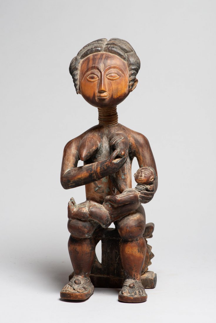 A Fine Ashanti Queen Mother sculpture, African Art: eac-4: Wood statue of Queen mother with child. H: 19, W: 6”, D: 7”. Ashanti, Ghana. Early 20th century. * Documentation / appraisal by Gregory Ghent to be included. Provenance: Donated by a member