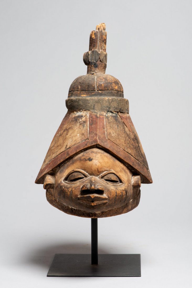 A Yoruba Gelede African Mask: A carved wooden Gelede helmet mask. Wood, pigments. H: 15.5”, W: 7.5”, D: 11”. Mid-20th cen. Yoruba. Nigeria. With stand Provenance: Donated by a member of The Ethnic Arts council of Los Angeles