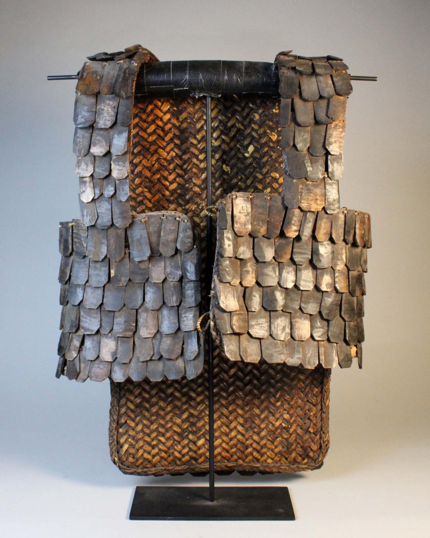 Tana Torajah Mens Armor Vest , Sulawesi, Indonesia: Man’s rattan war vest with buffalo shell armor. H: 26.5”, W: 19”. Early 20th century. Toraja peoples. Sulawesi Island, Indonesia. Comes with stand. Provenance: Donated by a member of The Ethnic 