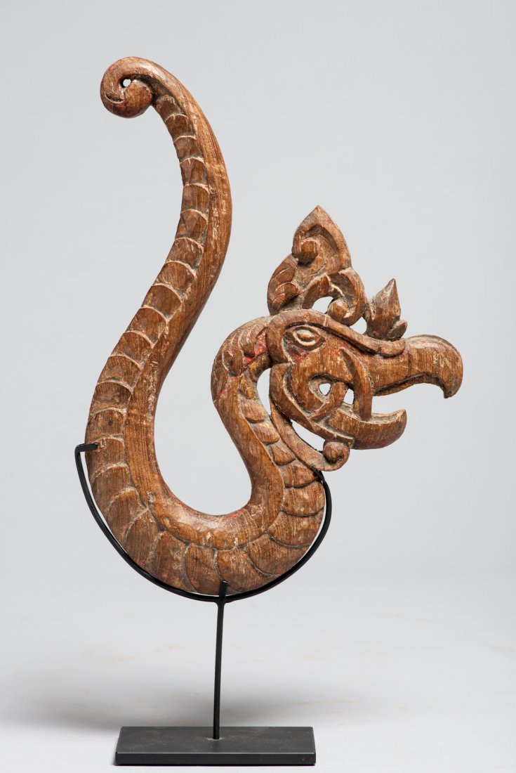 A Fine Javanese Carved Net Hook in The Form of a Dragon: A very finely carved old Mosquito net hook with dragon motif. H: 11”, W: 8”. Early-mid 20th century. Java Island, Indonesia. With stand. Provenance: Donated by a member of The Ethnic Arts council 