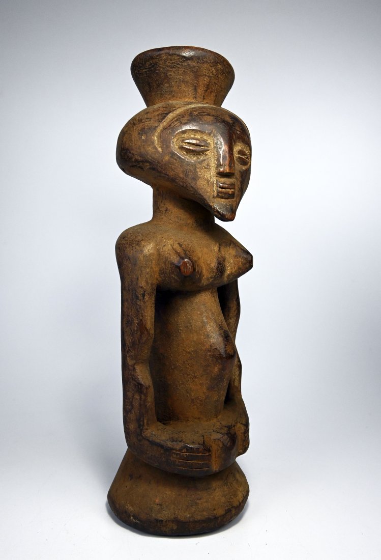 A Kusu Magic fetish, African Art: A carved wooden idol with carved "coffee bean" eyes and small and raised finial on top to hold a "magic" charge to empower the idol. Such figures were considered mediums to the spirit world. The figur
