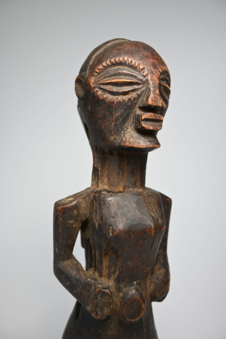 Songye Personal Shrine Figure Ex Leonard Kahan Gallery: A finely carved wooden personal charm figure with incised designs around the eyes and a well handled surface patina. Songye peoples, DRC/ Congo, central Africa. Measures 11.75 inches tall. Provenance: