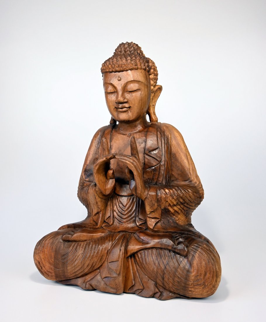 Carved Wooden Buddha In Teaching Pose: This is a finely carved contemporary Buddha shown in lotus position and with hands in the air in a teaching Pose. This Buddha was carved from Suar wood and originated in Sukawati village, central Bali