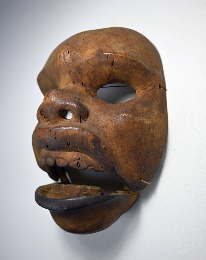 Early 20th century Topeng Mask from Bali Indonesia: Antique carved wooden drama mask with retractable jaw and carved teeth , open-work eyes and well handled surface patina. Balinese culture, Bali, Island, Indonesia. The mask measures 7 inches tall. Pro