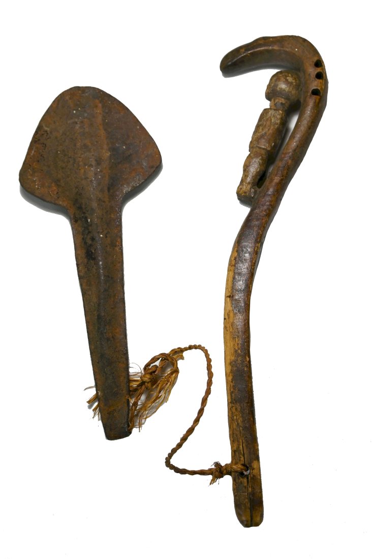 A Rare Baule Gong and Beater Ex Moses Asch 1959: A carved wooden gong striker with attached iron gong instrument. The well worn wooden gong striker has features a serpent and a ancestor figure, and has a deep well handled surface patina. Baule peopl