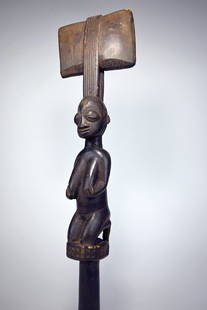 A Fine Old Yoruba Shango Dance Wand Ex Ladislas Segy: A tall carved wooden staff " Oshe Shango" featuring the image of a kneeling devotee of Shango, Yoruba peoples, Nigeria, Africa. Shango is the Yoruba god of thunder and lightning and the double-axe mot