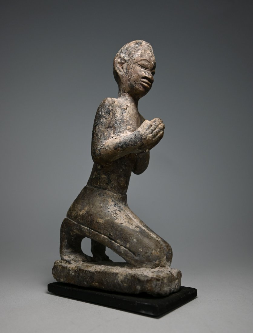 Rare Bakongo Kneeling Devotee Terracotta Ex Kahan: A very rare and serene effigy of a kneeling and praying Christian Convert with a weathered and encrusted surface suggesting good age. Bakongo peoples, central Africa. The figure is terracotta clay and