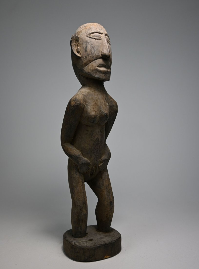Dramatic Naga female Ancestor sculpture: This is an antique carved wooden effigy of a female ancestor. The Naga, a fierce head hunting tribe were known for their use of trophy heads as part of their shrines and ritual dances. This figure mea