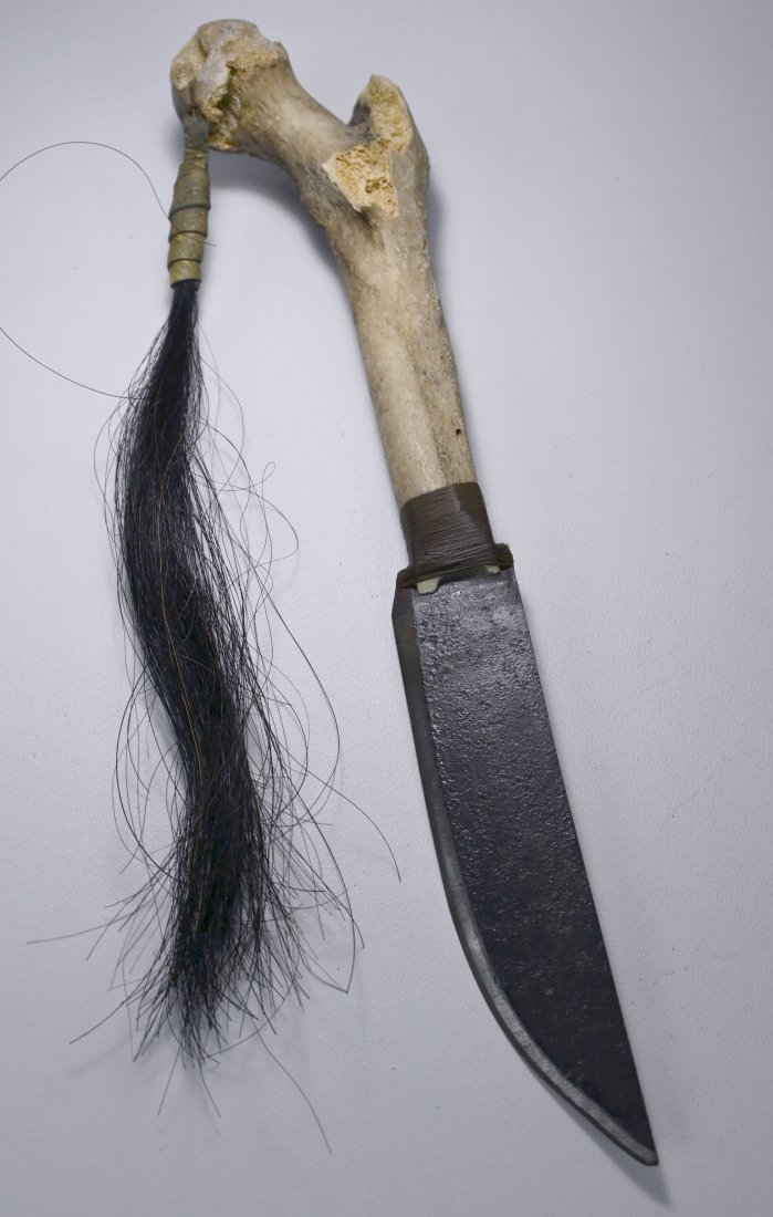 Ticuna Bone Dagger Collected Amazon Jungle 1970: A rare and Unusual Bone handled Dagger with tuft of hair as adornment and metal blade. Ticuna Indian, Amazon Jungle, Colombia. Provenance: Collected in situ in 1970 at the head waters of the Amazon Ri