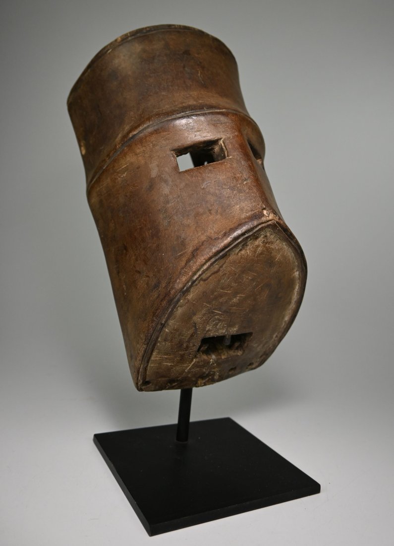A Highly Stylized Lega mask: A very unusual and highly stylized mask form, accented with kaolin clay pigment and a well handled surface. The mask was unlikely to have been worn, though may have been part of a costume or shrine ob
