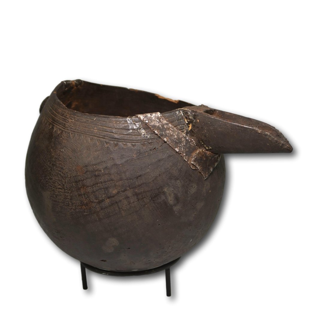 A Shi Wooden Vessel: Antique carved wooden vessel with long spout, incised designs and tribal repairs and reinforcements to areas with hammered aluminum. Shi peoples, DRC/ Congo, Africa. The Vessel measures 11.75 x 6 inch